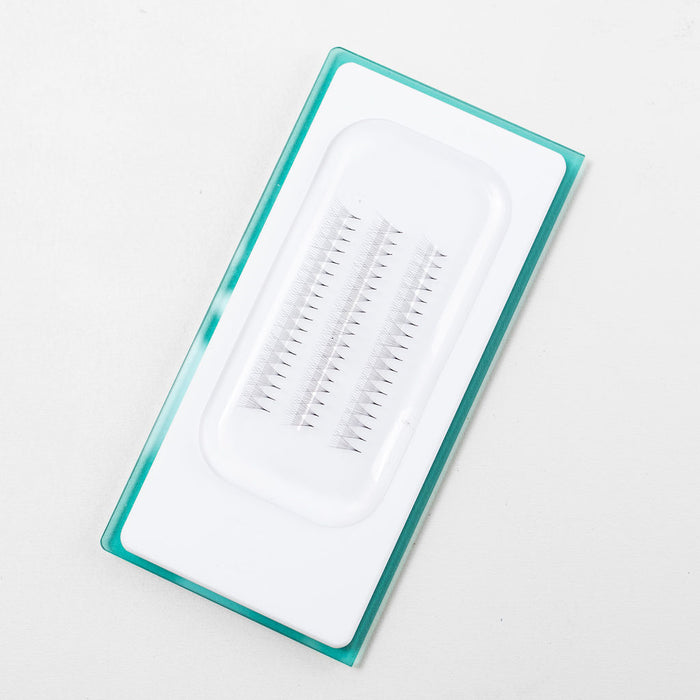 Premade lash fans arranged on a silicone pad for easy pickup and clean application—ready to dip and apply.